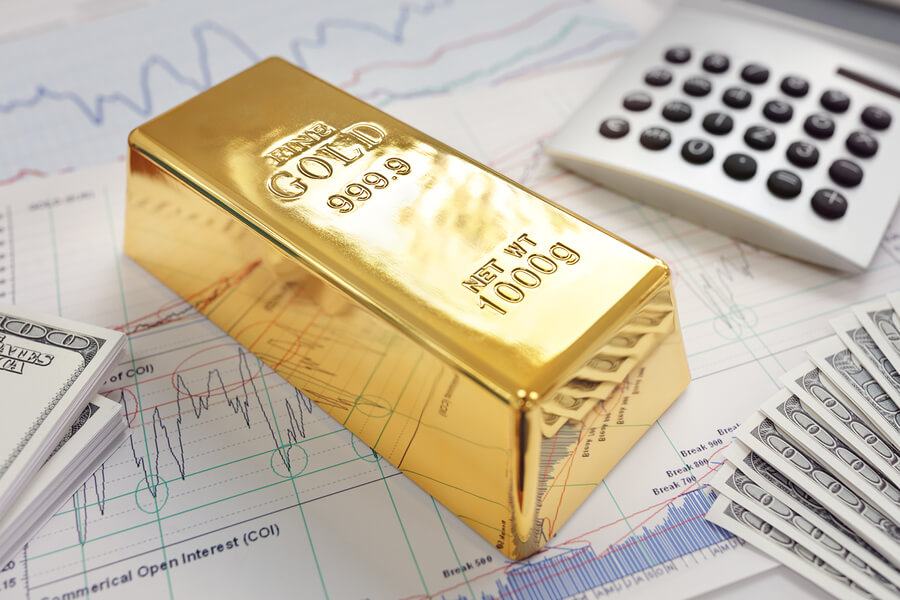No risk, no reward - Gold ingot resting on a stocks document